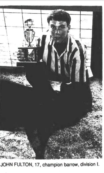 May be a black-and-white image of football and text that says 'MTA JOHN FULTON, 17, champion barrow, division I.'